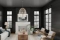 Living room modern minimalist studio chic with black walls, white furniture, natural light, transparent curtains, a sofa dark cushions, and light rug contrast floors must-try interior design trend!